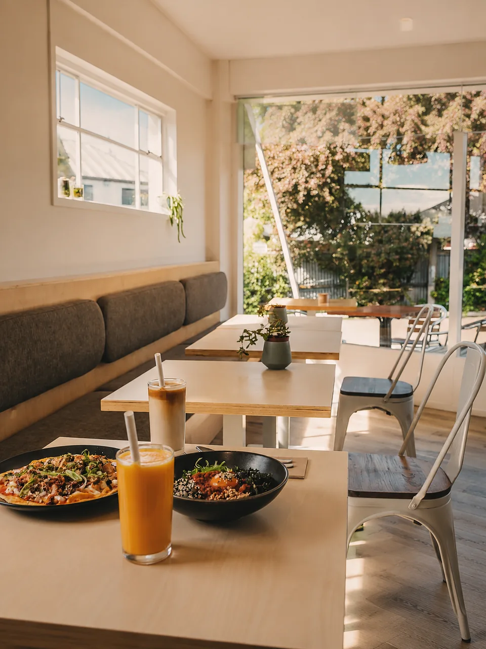 Sunlit PocaPoca seating with coffee and brunch on the table